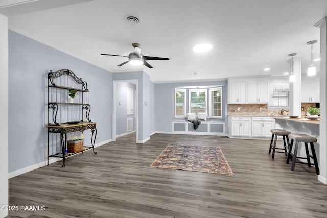 177 Radcliffe Dr, Lafayette, LA 70501 - living room featuring crown molding, dark wood-type flooring, ceiling fan, and recessed lighting