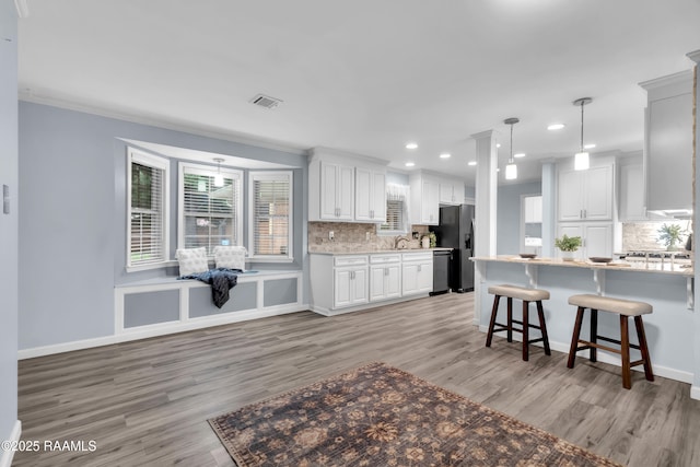 177 Radcliffe Dr, Lafayette, LA 70501 - kitchen featuring light wood finished floors, decorative backsplash, white cabinets, recessed lighting, and ornamental molding