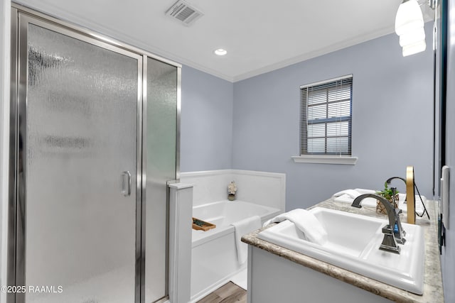 177 Radcliffe Dr, Lafayette, LA 70501 - bathroom featuring a shower stall, a bath, vanity, crown molding, and wood finished floors