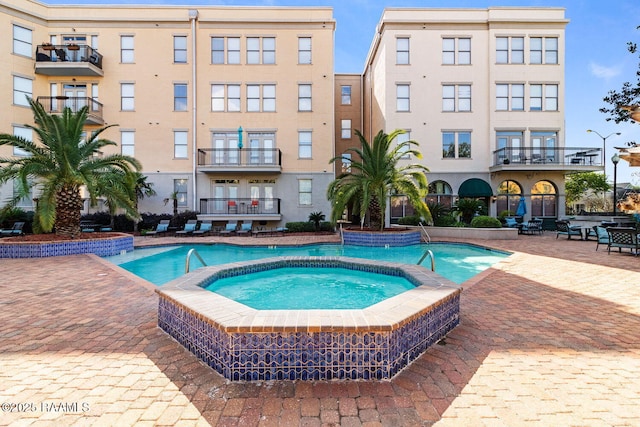 201 Settlers Trace Blvd Unit 4404, Lafayette, LA 70508 - community pool featuring a hot tub and a patio