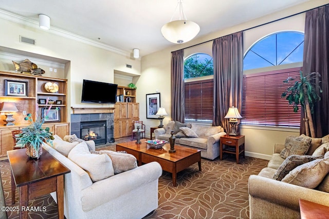 201 Settlers Trace Blvd Unit 4404, Lafayette, LA 70508 - living room featuring a tile fireplace, built in features, and crown molding