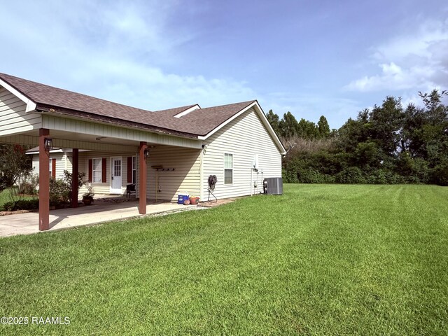 1108 Poydras Pl, Breaux Bridge, LA 70517 - view of home's exterior featuring a carport, roof with shingles, and a lawn