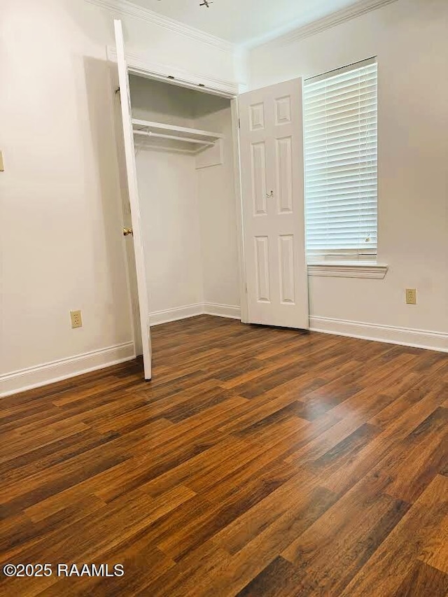 1108 Poydras Pl, Breaux Bridge, LA 70517 - unfurnished bedroom with a closet, dark wood-style floors, and crown molding