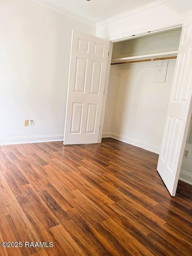 1108 Poydras Pl, Breaux Bridge, LA 70517 - unfurnished bedroom featuring dark wood-type flooring, a closet, and ornamental molding