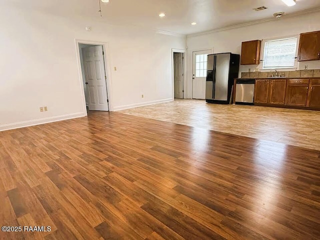 1108 Poydras Pl, Breaux Bridge, LA 70517 - unfurnished living room with ornamental molding, plenty of natural light, light wood-style floors, and recessed lighting