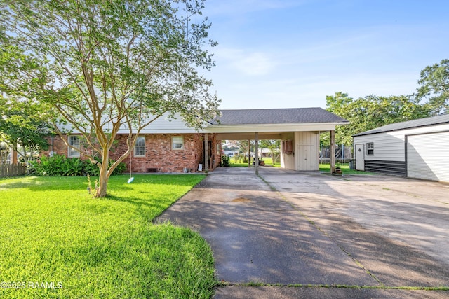 1054 Main St, Parks, LA 70582 - view of front of property featuring driveway, a front lawn, brick siding, and an outbuilding
