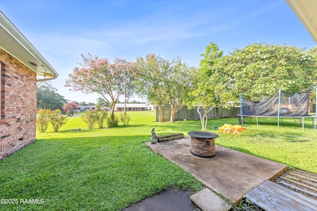 1054 Main St, Parks, LA 70582 - view of yard with a trampoline, a patio, and a fire pit