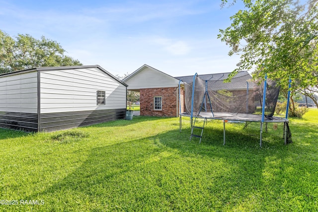 1054 Main St, Parks, LA 70582 - view of grassy yard featuring a trampoline