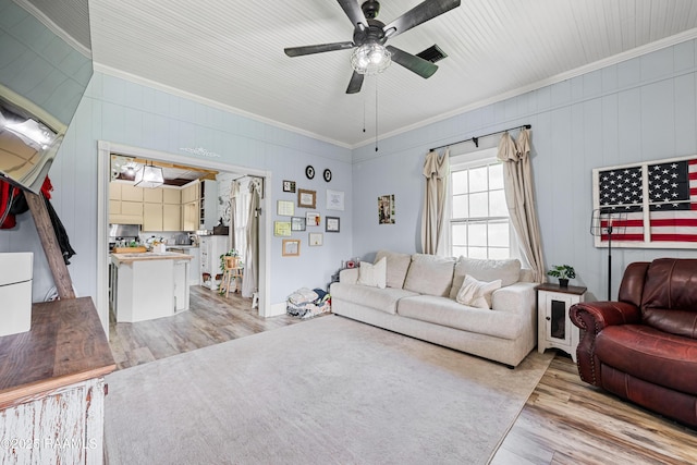 1054 Main St, Parks, LA 70582 - living area featuring light wood-style flooring, ceiling fan, and ornamental molding