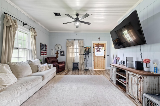 1054 Main St, Parks, LA 70582 - living area featuring crown molding, wood finished floors, healthy amount of natural light, and ceiling fan