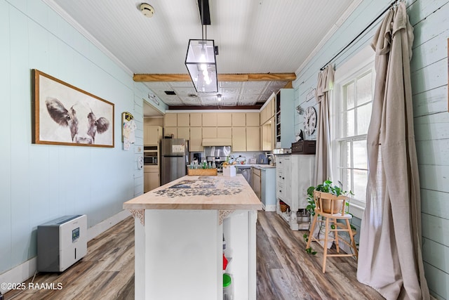 1054 Main St, Parks, LA 70582 - kitchen featuring stainless steel appliances, butcher block counters, wood finished floors, a kitchen island, and wood walls