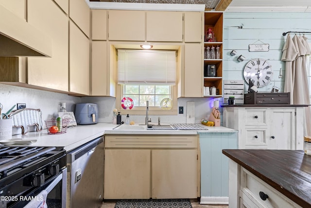 1054 Main St, Parks, LA 70582 - kitchen featuring dishwasher, open shelves, under cabinet range hood, cream cabinetry, and gas stove