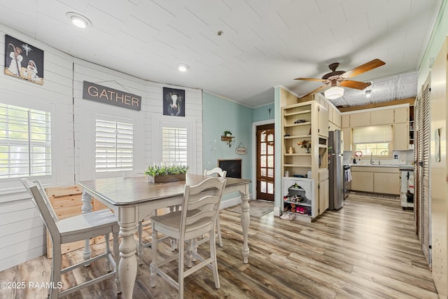 1054 Main St, Parks, LA 70582 - dining area with a ceiling fan and light wood-type flooring