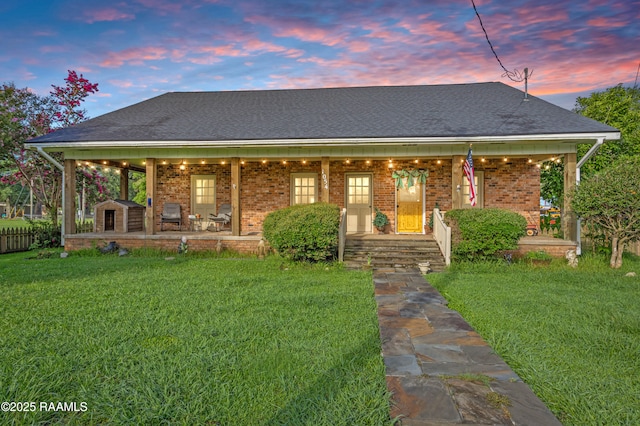 1054 Main St, Parks, LA 70582 - view of front of home featuring a storage unit, a porch, and brick siding