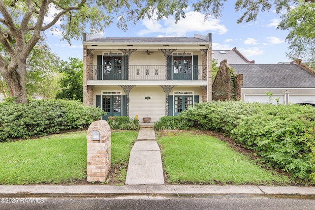 104 Georgetown Loop, Lafayette, LA 70506 - view of front of house with a balcony, a ceiling fan, a front yard, and a garage