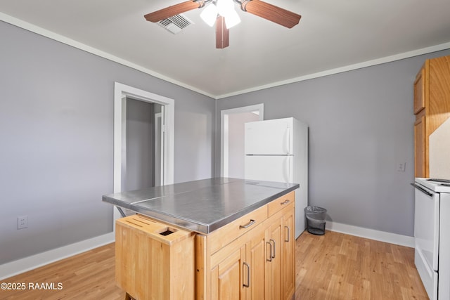 1044 Babineaux Rd, Breaux Bridge, LA 70517 - kitchen featuring stainless steel countertops, white appliances, ceiling fan, light wood-style floors, and light brown cabinets