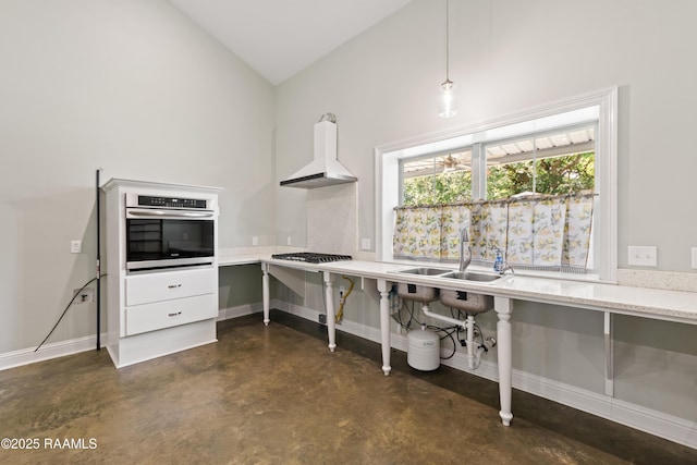 7011 Cameron St, Duson, LA 70529 - kitchen featuring oven, concrete flooring, custom range hood, vaulted ceiling, and light stone counters
