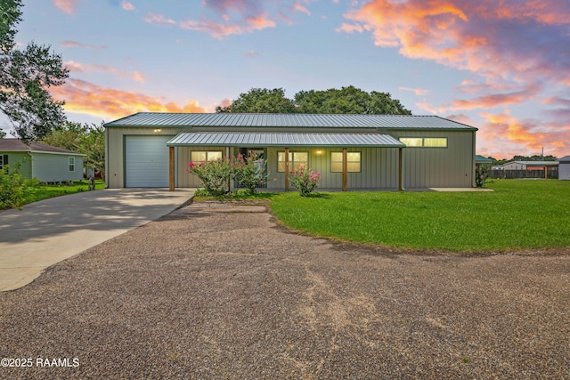 7011 Cameron St, Duson, LA 70529 - view of front of home with a lawn, driveway, an attached garage, and board and batten siding