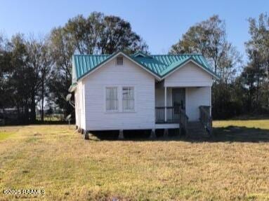 9028 La Cote Rd, Maurice, LA 70555 - view of front of property with a front yard, a porch, and a metal roof