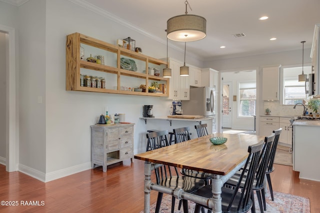 124 Buttercup Dr, Washington, LA 70589 - dining room featuring wood finished floors, ornamental molding, and recessed lighting