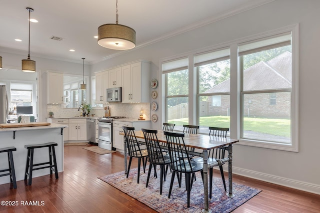 124 Buttercup Dr, Washington, LA 70589 - dining area featuring ornamental molding, dark wood finished floors, and recessed lighting