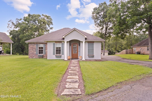 124 Buttercup Dr, Washington, LA 70589 - view of front of house with a front lawn, roof with shingles, and stucco siding
