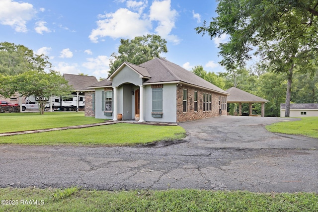 124 Buttercup Dr, Washington, LA 70589 - single story home featuring asphalt driveway, a front lawn, brick siding, and roof with shingles