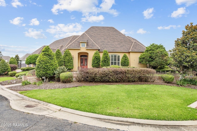 2 Carmel Bnd, New Iberia, LA 70563 - french country inspired facade featuring stucco siding, a front yard, and a shingled roof