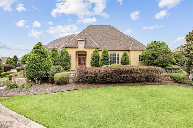 2 Carmel Bnd, New Iberia, LA 70563 - french country home with stucco siding, a front lawn, and a shingled roof
