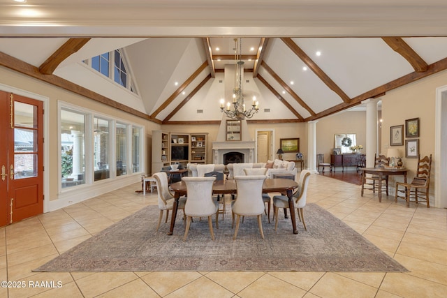 2 Carmel Bnd, New Iberia, LA 70563 - dining area with tile patterned floors, beam ceiling, high vaulted ceiling, a chandelier, and a fireplace