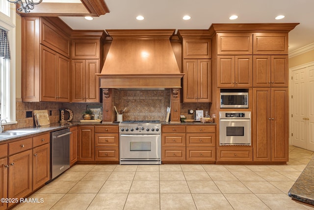 2 Carmel Bnd, New Iberia, LA 70563 - kitchen with appliances with stainless steel finishes, custom range hood, crown molding, dark countertops, and brown cabinetry
