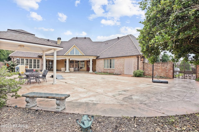 2 Carmel Bnd, New Iberia, LA 70563 - back of property featuring brick siding, a patio area, and roof with shingles