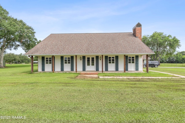 1243 Huval Rd, Breaux Bridge, LA 70517 - view of front of home with a front lawn, a chimney, roof with shingles, and covered porch