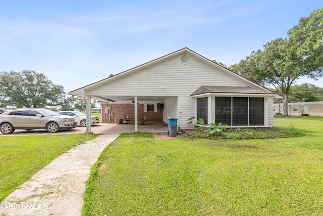 1243 Huval Rd, Breaux Bridge, LA 70517 - rear view of property featuring a yard, a sunroom, and brick siding