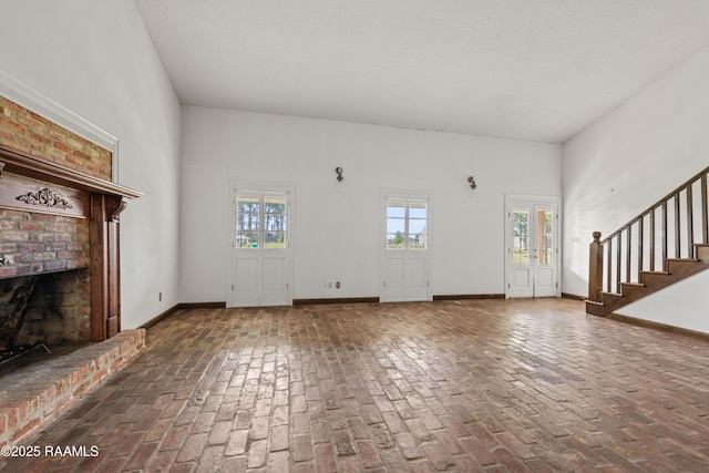 1243 Huval Rd, Breaux Bridge, LA 70517 - unfurnished living room with brick floors, a fireplace, and stairway