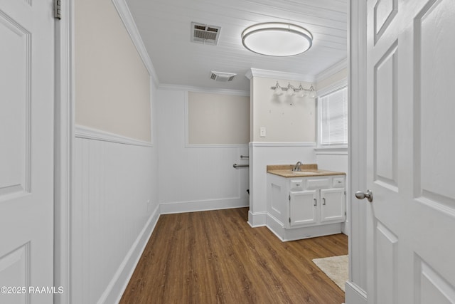 1243 Huval Rd, Breaux Bridge, LA 70517 - hallway with crown molding, dark wood-type flooring, and wainscoting