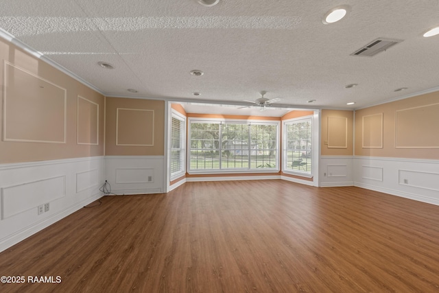 1243 Huval Rd, Breaux Bridge, LA 70517 - empty room with a decorative wall, a ceiling fan, wood finished floors, a textured ceiling, and ornamental molding