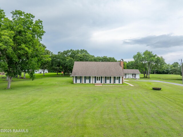 1243 Huval Rd, Breaux Bridge, LA 70517 - view of front of property featuring a front lawn, a chimney, driveway, and covered porch