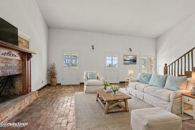 1243 Huval Rd, Breaux Bridge, LA 70517 - living room with healthy amount of natural light, brick flooring, a fireplace, and stairs