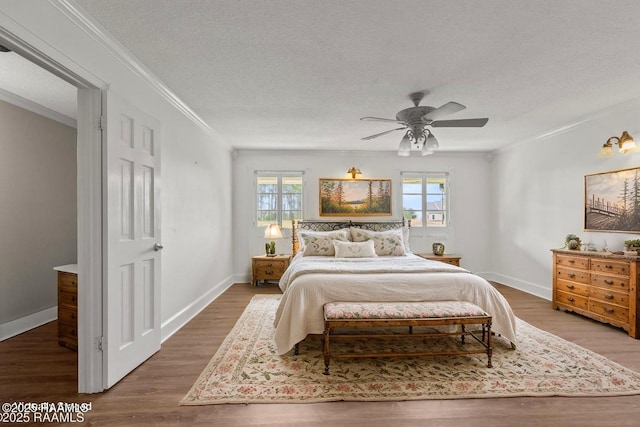 1243 Huval Rd, Breaux Bridge, LA 70517 - bedroom with crown molding, wood finished floors, a textured ceiling, and ceiling fan