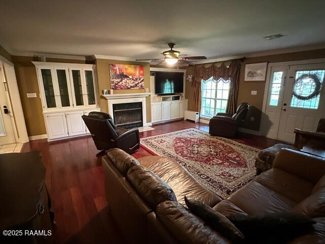 2033 Isadore Rd, Erath, LA 70533 - living area with a fireplace with flush hearth, ceiling fan, dark wood-type flooring, and ornamental molding
