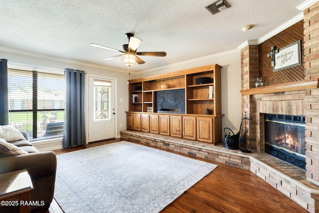 314 Creswell Ave, Scott, LA 70583 - living room featuring a fireplace, a textured ceiling, wood finished floors, a ceiling fan, and ornamental molding