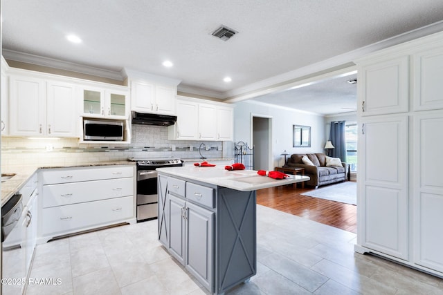 314 Creswell Ave, Scott, LA 70583 - kitchen featuring appliances with stainless steel finishes, under cabinet range hood, crown molding, open floor plan, and white cabinetry