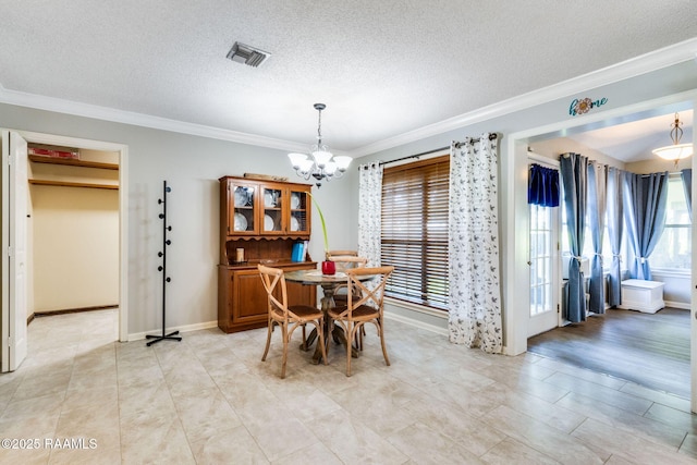 314 Creswell Ave, Scott, LA 70583 - dining area featuring a chandelier, ornamental molding, and a textured ceiling