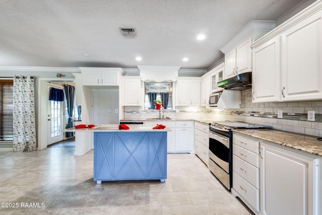 314 Creswell Ave, Scott, LA 70583 - kitchen featuring appliances with stainless steel finishes, under cabinet range hood, crown molding, a center island, and white cabinets