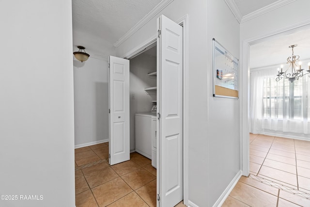 15 Courtyard Cir, Lafayette, LA 70508 - hallway with light tile patterned floors, ornamental molding, washer / dryer, and a chandelier