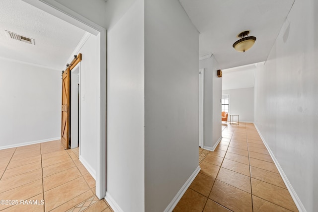 15 Courtyard Cir, Lafayette, LA 70508 - corridor featuring a barn door, light tile patterned floors, and crown molding