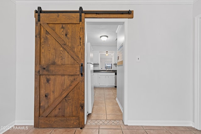 15 Courtyard Cir, Lafayette, LA 70508 - hallway with light tile patterned flooring, crown molding, and a barn door