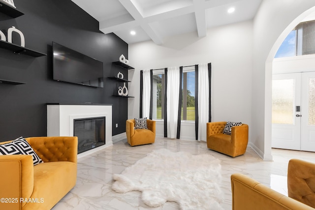 1114 Dermelie Calais Rd, Breaux Bridge, LA 70517 - living area featuring marble tiled floors, beam ceiling, a glass covered fireplace, recessed lighting, and a towering ceiling