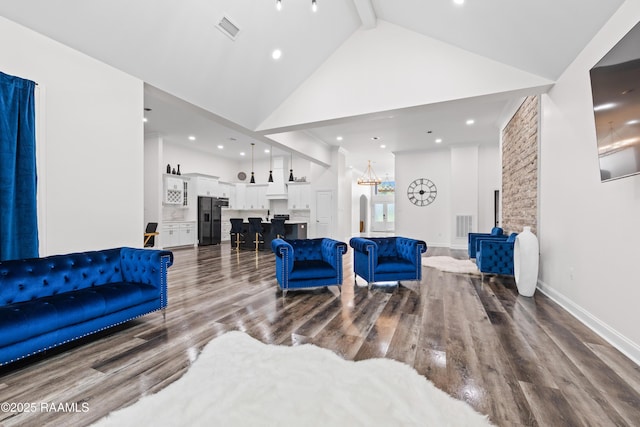 1114 Dermelie Calais Rd, Breaux Bridge, LA 70517 - living area with high vaulted ceiling, wood finished floors, recessed lighting, beamed ceiling, and a chandelier